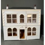 A wooden white painted dolls house with adjoining conservatory height 60 26x59