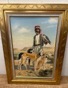An oil on canvas of a middle Eastern hunter and his dogs by Donald Grant OBE 60cm x 90cm