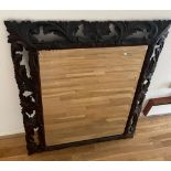A plank backed Oriental mirror with foliate frame (89cm x 104cm)