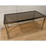 A mid-century brass smoked glass topped coffee table. Height 42 and 45x90