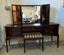 A Stag Minstrel dressing table and stool, comprising of a central single drawer, two drawers