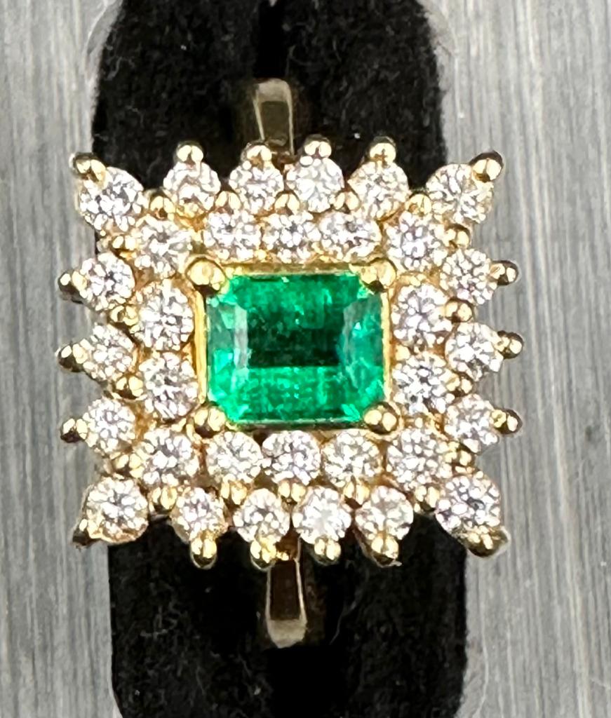 18 carat yellow gold emerald and diamond cluster ring.