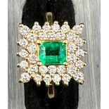 18 carat yellow gold emerald and diamond cluster ring.