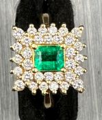 18 carat yellow gold emerald and diamond cluster ring.