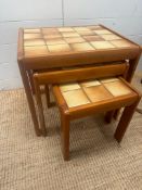 A nest of three Mid Century tile topped tables