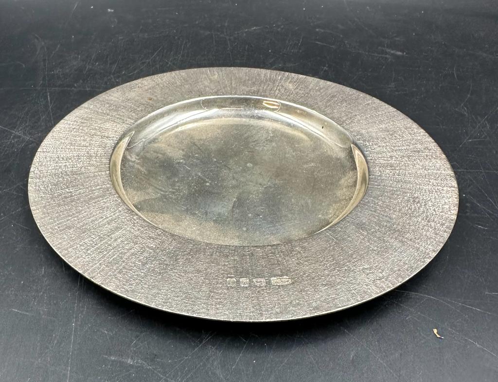 Christopher Nigel Lawrence silver offertory style plate with textured surround. Hallmarked for