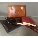 A selection of leather items to include two bound notebooks, an album and a portfolio.