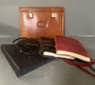 A selection of leather items to include two bound notebooks, an album and a portfolio.
