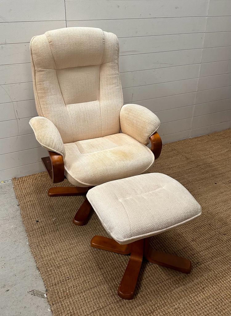 A white upholstered chair with matching footstool