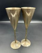 Two silver champagne flutes by Stuart Devlin on textured gilt stems (Approximate weight 406g) H