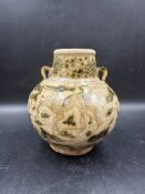 An oriental two handled jar with green painted dragon and floral decoration under a crackle glaze