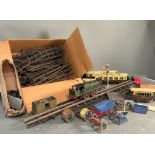 A Selection of tin model railway track, rolling stock an buildings