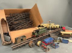 A Selection of tin model railway track, rolling stock an buildings