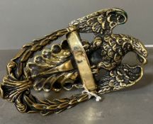 A brass eagle themed door knocker.