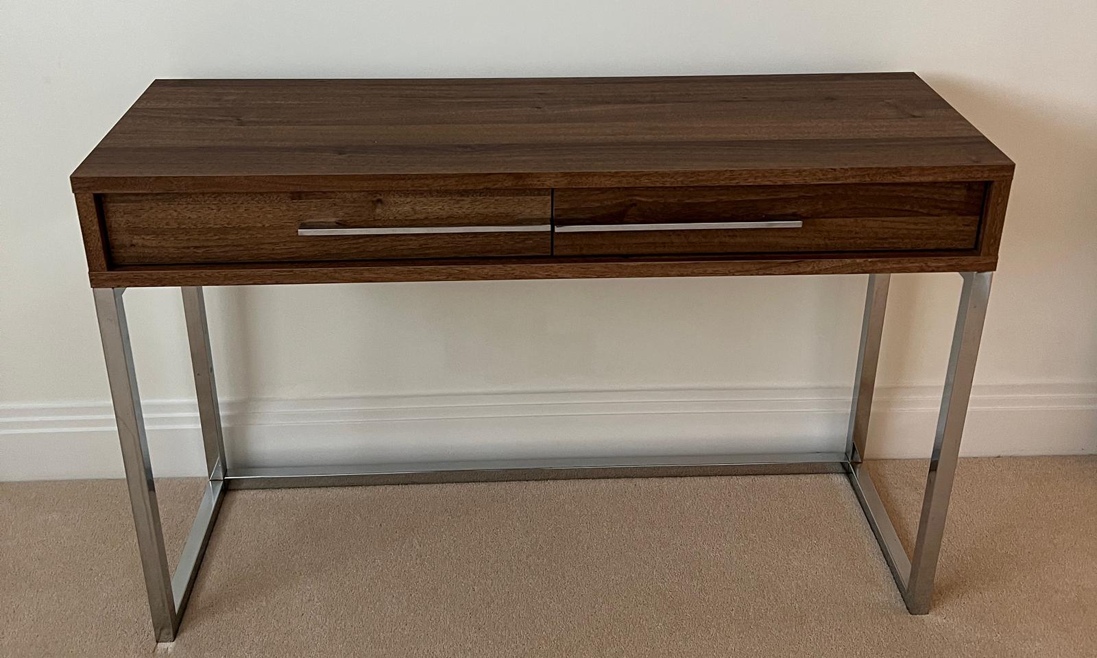 A console table on chrome legs and drawers to centre (110cm x 35cm x 72cm)