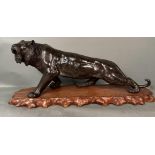 A large bronze lion on stand Japanese Meiji period 19th Century (H32cm W77cm)