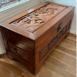 A camphor chest with brass fittings and carved pastural scene (74cm x 36cm x 40cm)