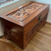 A camphor chest with brass fittings and carved pastural scene (74cm x 36cm x 40cm)