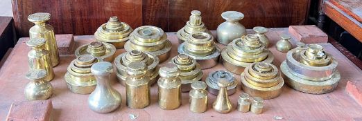 A sizeable selection of brass scale weights various makers and styles.