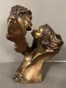 A bronze sculpture of a man and a women embracing titled "Desire" (H38cm)