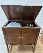 A vintage Victoria record player and a collection of record