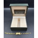 A Ladies Gucci watch in gold metal, boxed