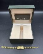 A Ladies Gucci watch in gold metal, boxed