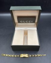 A Ladies Gucci watch in gold metal, boxed