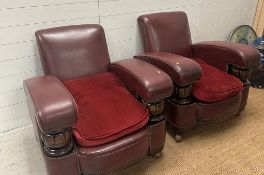 A two seater faux leather oxblood sofa with carved oak arm supports and two matching chairs