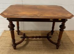 An octagonal occasional table on turned legs and rimed central stretcher (H75cm W110cm D65cm)