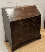 An oak two over three bureau opening to four drawer, lockable cabinet and six storage compartments