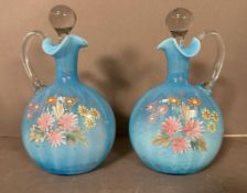 Two Victorian milk blue hand blown and hand painted glass decanters with floral detail