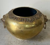 A large brass jardinière with lion masks and ring handles (H38cm W67cm)
