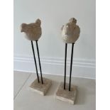 Two statues of faux stone birds