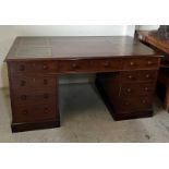 A Partners desk in mahogany four green leather writing corners drawers to one side cupboards to