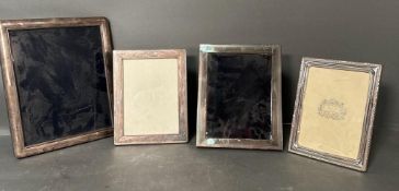 A selection of four silver photograph frames the largest being 29.5cm x 24cm