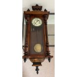 An eight day regulator wall clock by Gustav Becker in a walnut case c1880 . Weights, pendulum and