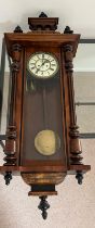 An eight day regulator wall clock by Gustav Becker in a walnut case c1880 . Weights, pendulum and