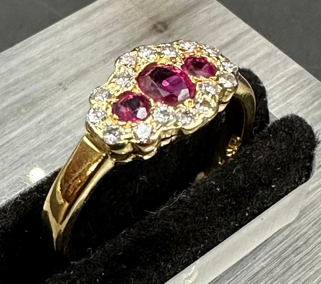 18 carat yellow gold ruby and diamond 3 stone cluster ring. Full hallmark