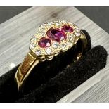 18 carat yellow gold ruby and diamond 3 stone cluster ring. Full hallmark