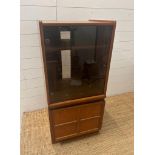 A Mid Century Nathan Atlas music cabinet with glass door and cupboard under (H111cm W52cm D46cm)