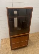 A Mid Century Nathan Atlas music cabinet with glass door and cupboard under (H111cm W52cm D46cm)
