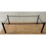 A Mid Century glass coffee table on a metal frame (H37cm W110cm D50cm)