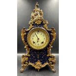 A Rococo style mantel clock with enamel face in royal blue with gilt fleur detail