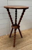 A mahogany circular occasional or Gypsy table on bobbin tripod legs with central turned finial (