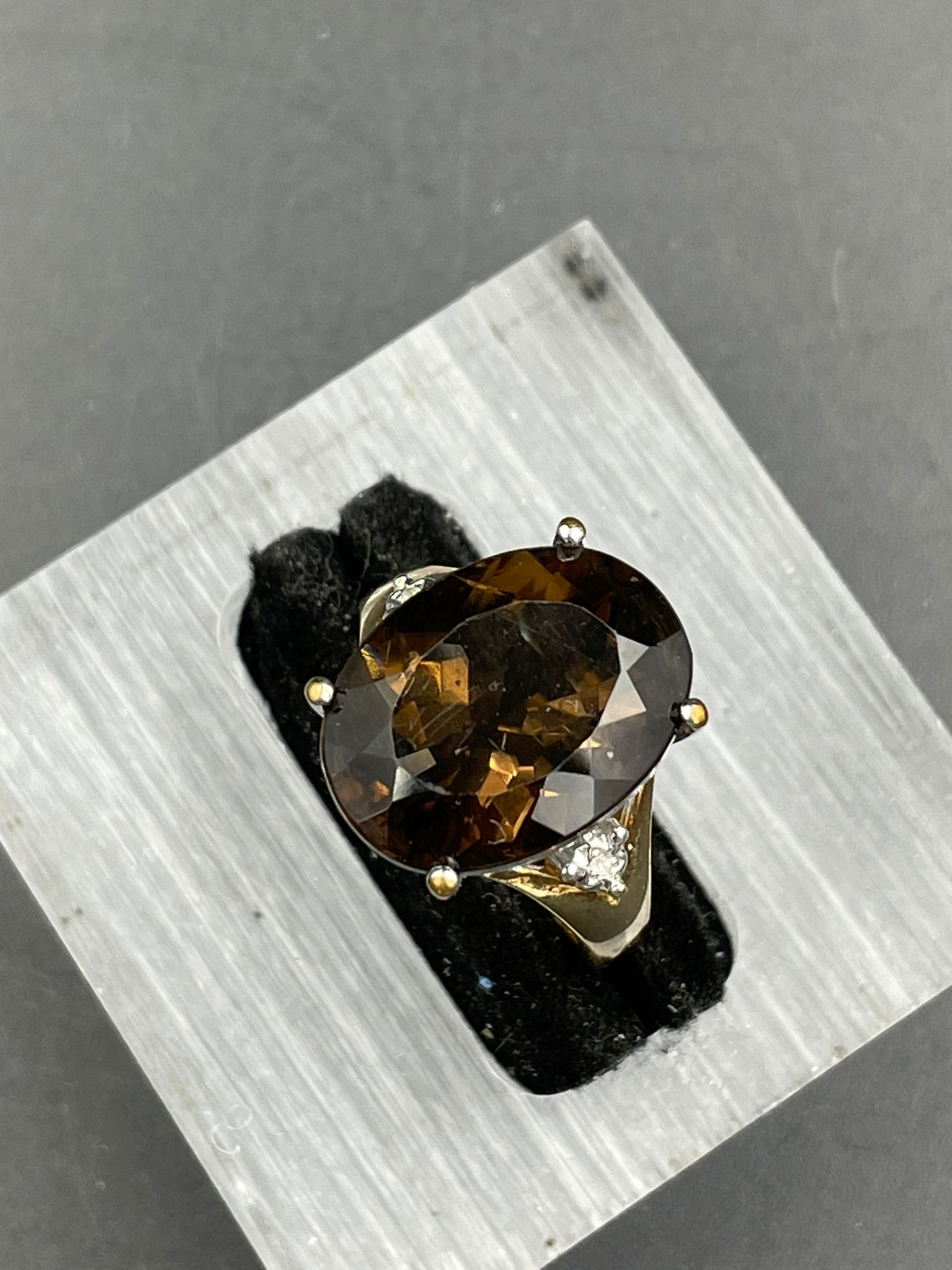 A smokey quartz and diamond ring, oval cut smoky quartz weighing on a 7.20ct claw set with a - Image 3 of 4