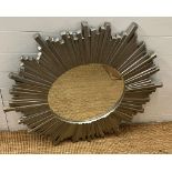 A contemporary circular star burst style mirror