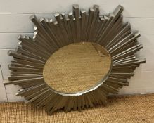 A contemporary circular star burst style mirror