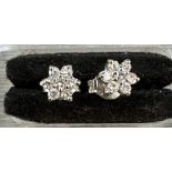 18 carat white gold diamond star earrings, each comprising 7 round brilliant diamonds