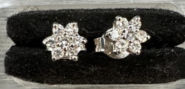 18 carat white gold diamond star earrings, each comprising 7 round brilliant diamonds